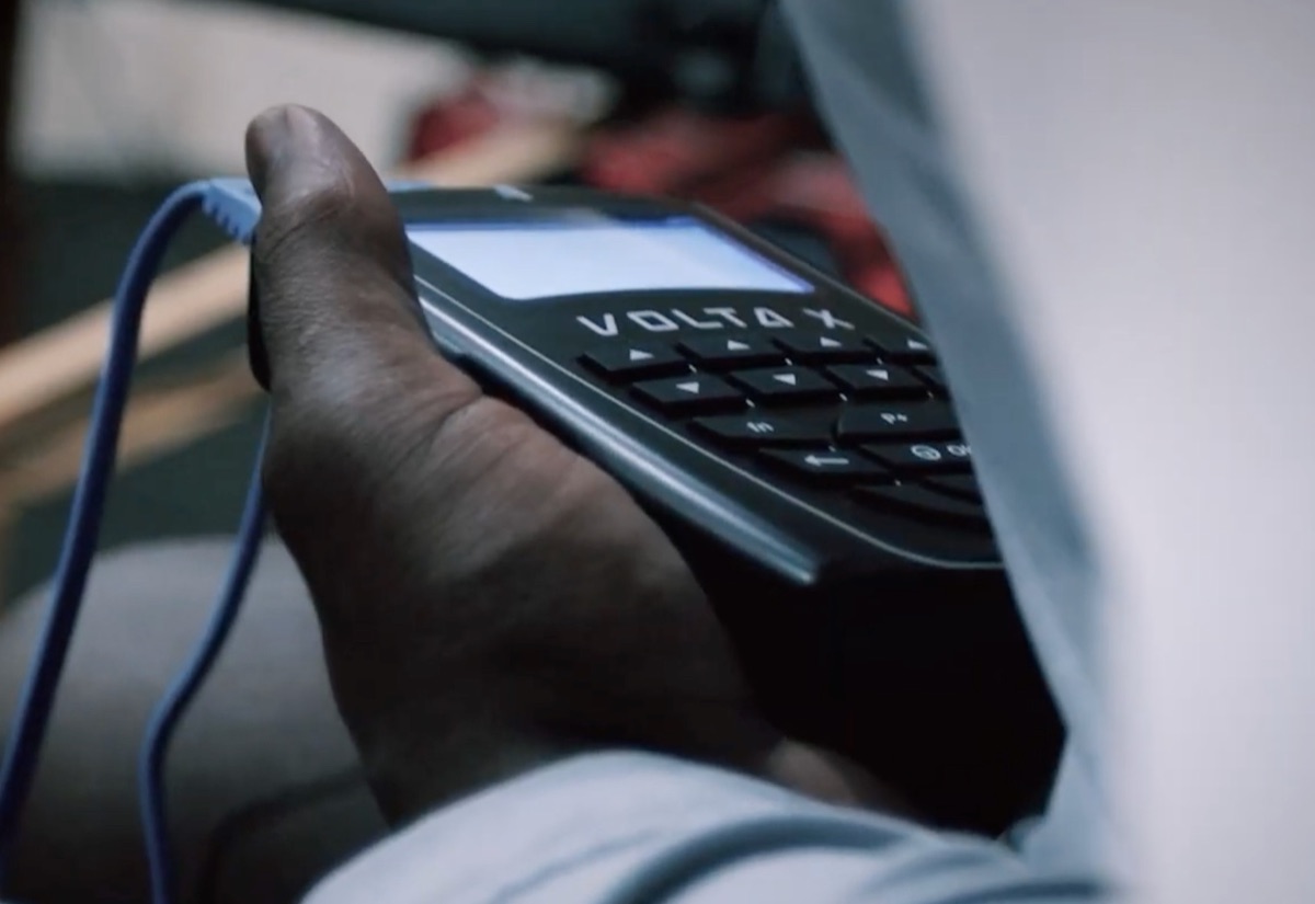 The Volta X direct current stimulation device held in a hand during a training session