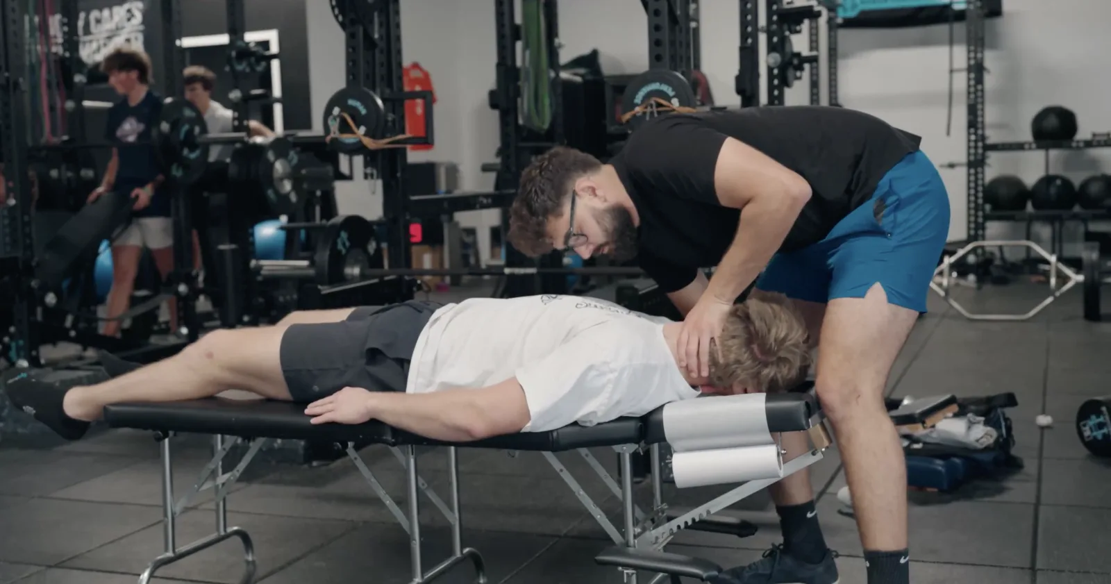 Dr. Jarod Burton, DC, performing hands-on rehabilitation with an athlete at Accelerate ACL